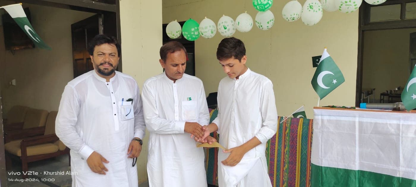 Principal Giving Cash Prize to the Topper